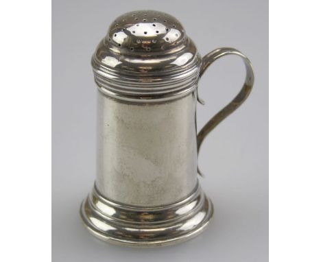 FRT and Co, a Britannia silver ' tankard' pepper, with domed cover, scroll handle on stepped circular foot. London 1935, 8.5c