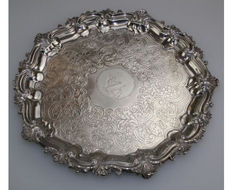 Waterhouse, Hodgson and Co, a William IV silver salver with scrolling shell cast rim and foliate chasing around a shield cres
