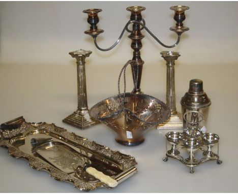 A quantity of Victorian and later silver plated wares, including scroll branch table candlesticks, snuffer and other trays, b