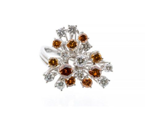 A diamond and 18ct white gold cluster, comprising a twisted claw setting of round cut cinnamon and cognac diamonds , the larg