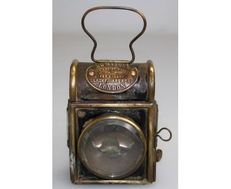Shand Mason and Co, an Edwardian brass mounted steel fire engine oil lamp of domed form with bevelled front and side glasses,