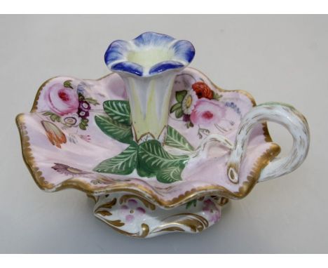 An early 20th century Spode porcelain chamberstick with trumpet flower sconce and petal pan, florally decorated on a pink and