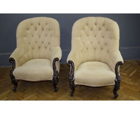 A pair of Victorian framed, sand button upholstered parlour armchairs, each having hoop back, scroll leaf carved outswept arm