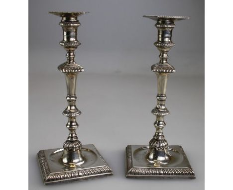 Ebenezer Coker, a pair of George III silver candlesticks, each having detachable pan, gadrooned knop stem and dished, crested
