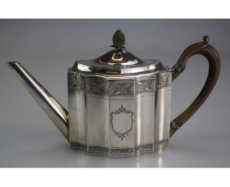 Abraham Taylor, a George III silver teapot of concave panelled form, the slightly domed cover with stained pineapple finial o