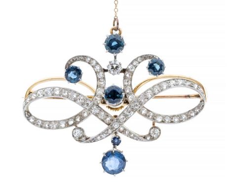 A Belle Époque sapphire and diamond 18ct gold pendant/brooch, comprising symmetrical open scrolls grain set with old cut diam