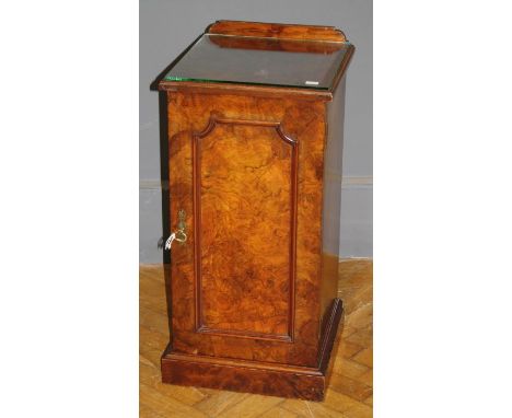 An Edwardian figured walnut pot cupboard, the panel door with brass furniture, enclosing two shelves on plinth. 80 x 38cm