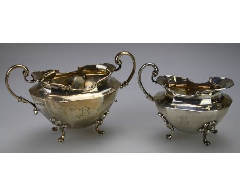 Sibray, Hall and Co Ltd, a silver twin scroll handle sugar of octagonal panel form on four leaf cast knuckle feet, together w