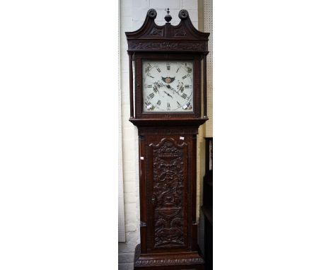 An early 19th century oak longcase clock, the thirty hour bell striking movement faced by Roman Moon roller dial in a carved 