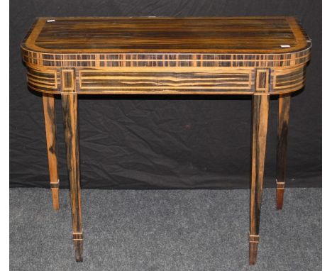 A good, late George III coromandal card table, the D shape burr yew crossbanded folding top supported by double gate, on squa