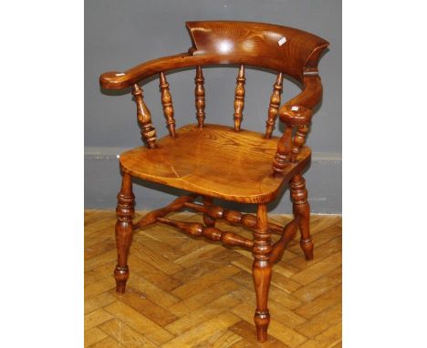 The Real Wood Furniture Co, a beech and elm captain's chair, having a hoop back, bobbin splats, saddle seat on baluster turne