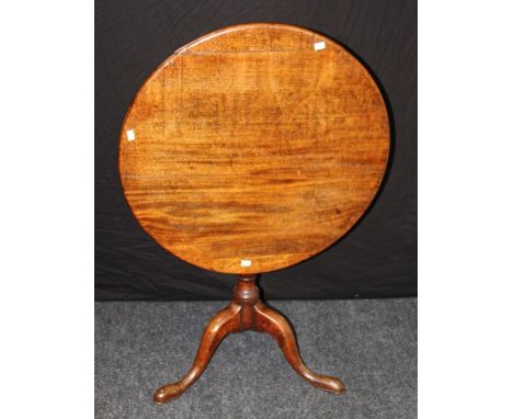 A late 18th century mahogany tripod table, the circular snap top on ring turned column, downswept legs and pad feet, 76cm dia