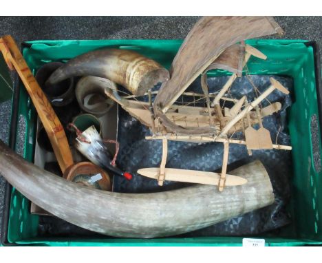 Box containing horn beakers, wooden boat, ornamental ladle with picture of a fish, wooden goblet adorned with a rhinoceros et