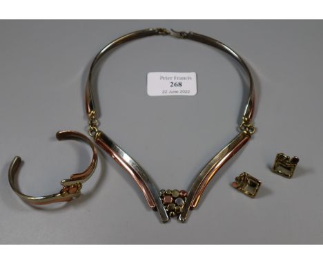 A Modern suite of jewellery in copper and brass.  Necklace, bangle and earrings.(B.P. 21% + VAT) 