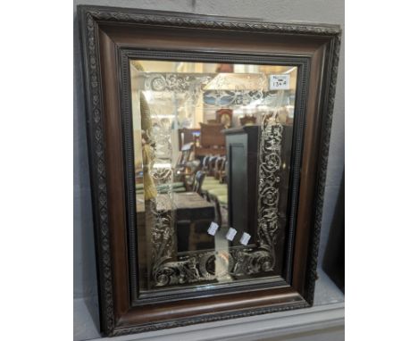 Engraved heavy bevelled glass mirror with scroll work decoration within a mahogany finish frame. The plate 44 x 30cm approx. 
