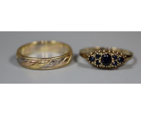 An 18ct three colour gold wedding ring and a 9ct gold sapphire ring.  Ring size N and M.  Approx weight 4.8g.(B.P. 21% + VAT)