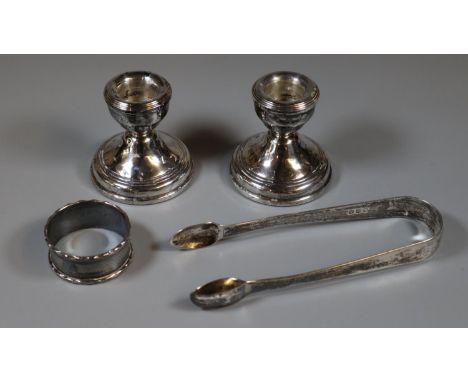 Small collection of silver items to include: sugar nips, engine turned napkin ring and a pair of dwarf candle sticks.  (4)  (