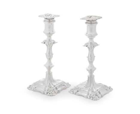 A PAIR OF GEORGE II STYLE CANDLESTICKSBy Henry Wilkinson &amp; Co, London, 1892 On square shell-moulded bases and engraved wi