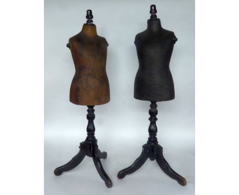 TWO SIMILAR LATE VICTORIAN JAPANNED BEECH WOOD AND LEATHERETTE SHOP DISPLAY CHILD'S GARMENT MANNEQUINS, on tripod bases, heig