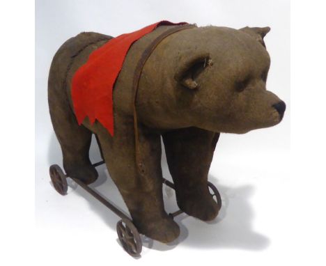 EARLY 1900s, PROBABLY STEIFF, WOOD-STRAW FILLED CHILD'S PULL-ALONG RIDE-UPON BEAR with iron frame and wheels, originally with