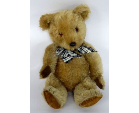 A CIRCA 1960 CHILTERN GOLDEN PLUSH TEDDY BEAR with velour pads, black plastic nose and glass eyes 21" (53.5 cm) long