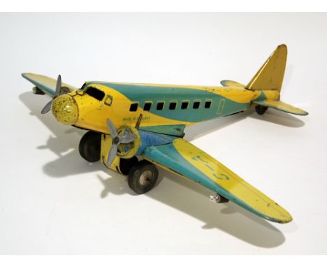 CIRCA 1950s LITHOGRAPH TIN PLATE DAKOTA TYPE PASSENGER AIRCRAFT moving on clockwork wheels, the wing detachable to fit batter