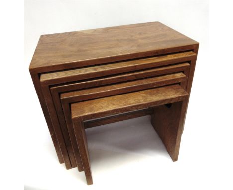 A NEST OF FIVE ERCOL LIGHT ELM COFEE TABLES  with exposed dovetail joints and carved pierced handles to each side, the larges