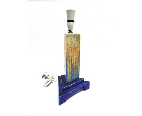 A RUSKIN POTTERY TABLE LAMP  with streaked ochre and blue crystalline glaze, of triangular pillar form on conforming stepped 