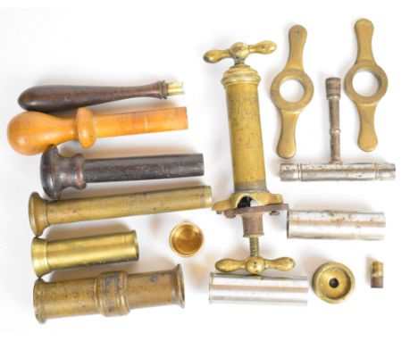 A collection of mainly 10 and 12 bore gun and reloading tools including T-shaped nipple key, resizing tools, double ended bra