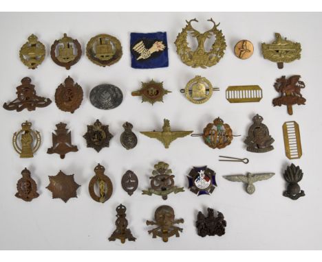 Small collection of mainly British Army cap badges including Royal Armoured Corps, The Buffs, Dorsetshire Regiment, Parachute