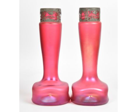 A pair of Loetz iridescent pink glass vases of rounded and dimpled square form with elongated necks and metal collars decorat