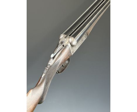 F Baxter 10 bore side by side shotgun with engraved lock, trigger guard, thumb lever, fences and underside, chequered semi-pi