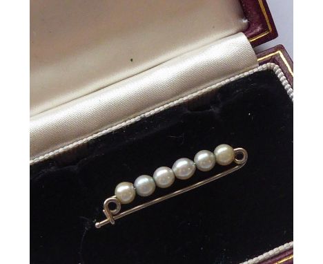 A boxed stick pin set with six pearls&nbsp;