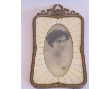 An early 20th century brass-mounted and ivory photograph frame, the pediment with ribbons and laurel leaves in late 18th cent