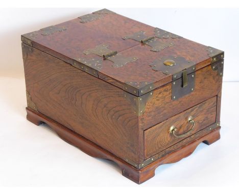 A Korean elm and brass-mounted travelling vanity case, the hinged lid lifting up to reveal an angular mirror with hand-bevell