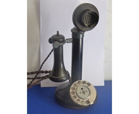 An early/mid-20th century black-painted metal (with Bakelite speaker) candlestick telephone (31cm high)&nbsp;