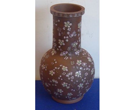 A Japanese pottery vase (probably early 20th century) hand-decorated in enamels in relief with prunus blossom (27.5cm high)