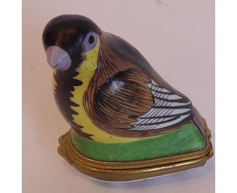 A 19th century gilt-metal mounted porcelain patch box modelled as a small bird, the interior of the underside opening to reve