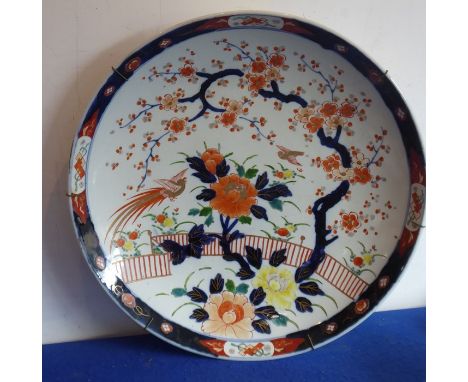 A large late 19th century Japanese porcelain circular charger, cobalt-blue border decorated with various symbols in reserves 