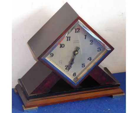 A striking Art Deco period  and design Bakelite mantel clock of lozenge form, the silvered dial with Arabic numerals and sign