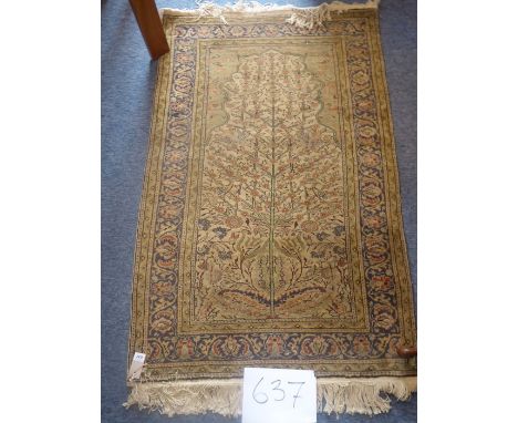 A hand-knotted Persian prayer rug, predominantly mustard/light-brown ground and the tree of life-style motif within varying s