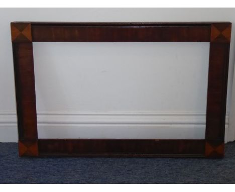 An early 19th century rosewood painting frame; each corner decorated in relief with rosewood and maple triangular sections (6