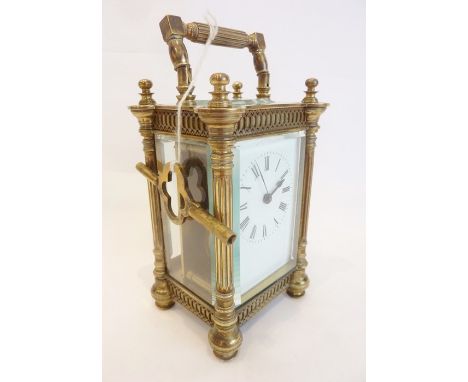 A late 19th century brass-cased carriage clock in 4-pillared case with blind fretwork friezes