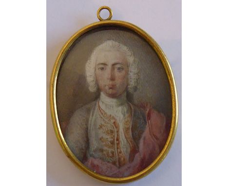 A small oval gilt-metal-framed mid-18th century shoulder-length portrait miniature of a gentleman of finery, white-powdered w