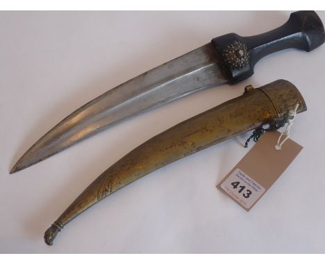 A late 19th/early 20th century middle Eastern Yemeni jambiya dagger, shaped ebonised handle headed with a circular domed boss