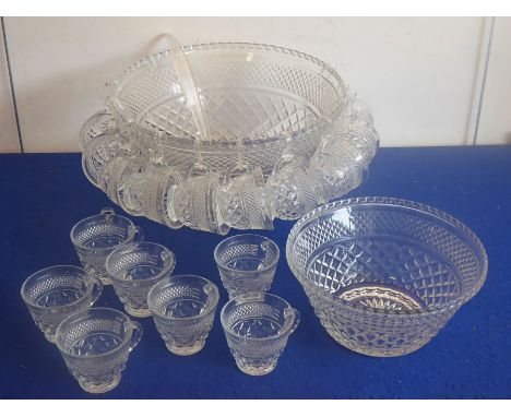 A large pressed clear-glass punch bowl together with 18 punch cups, plastic hooks, a plastic ladle and one further smaller ma