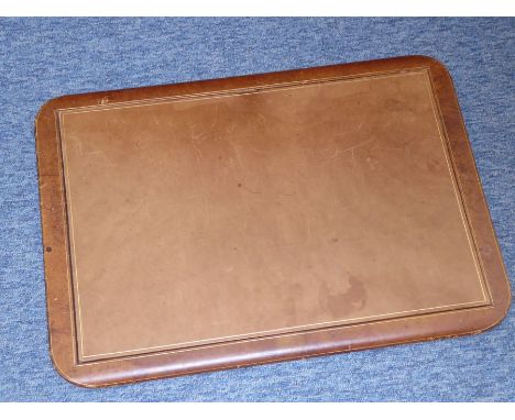 A rectangular light-tan-leather desk blotter/writing surface, the gilt-tooled centre section removable, and the back detailin