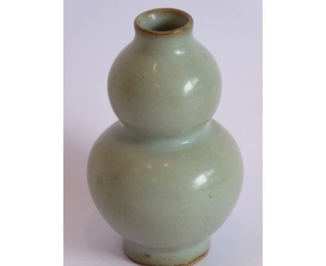 A Chinese Ming Dynasty double gourd form vase displaying a Ru/light celadon glaze, raised on short circular foot, 9.5cm high&