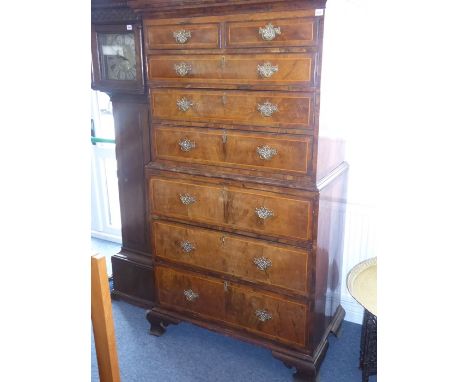 A mid-18th century walnut crossbanded and boxwood strung chest on chest, the carvetto style cornice above two half-width and 