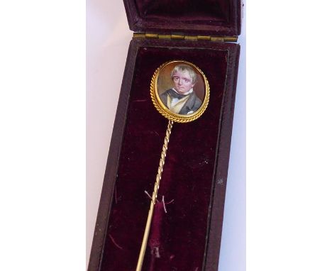 A 19th century yellow-metal and oval porcelain mounted stick pin (boxed) the portrait miniature probably of Sir Walter Scott 